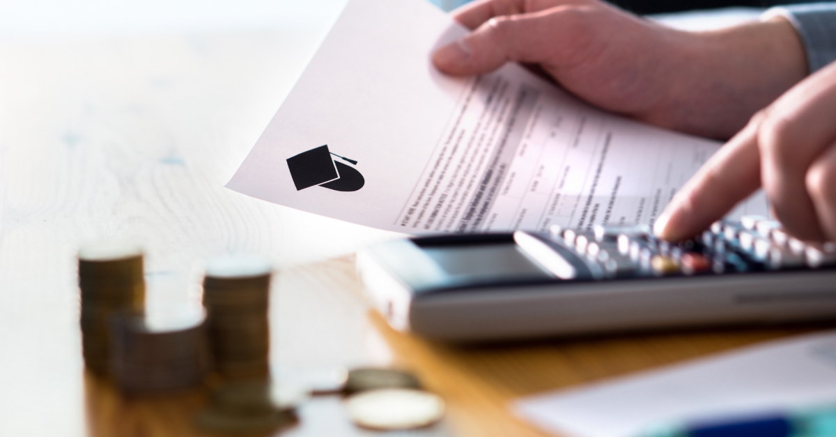 man using calculator and reviewing papers to calculate fees