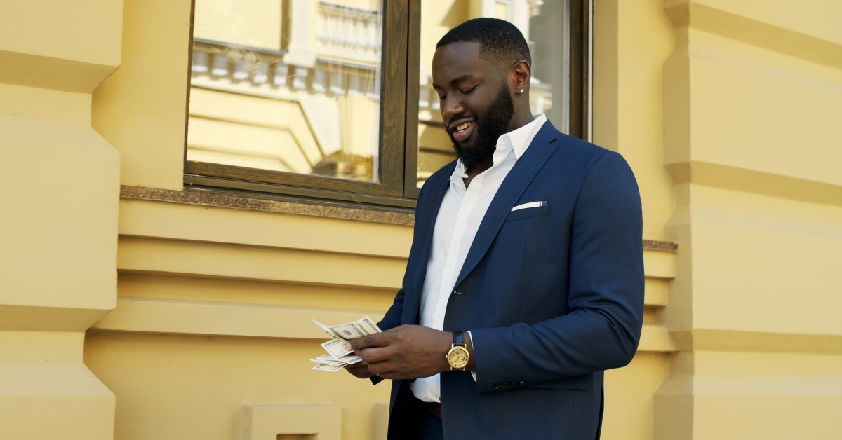 man counting money outside