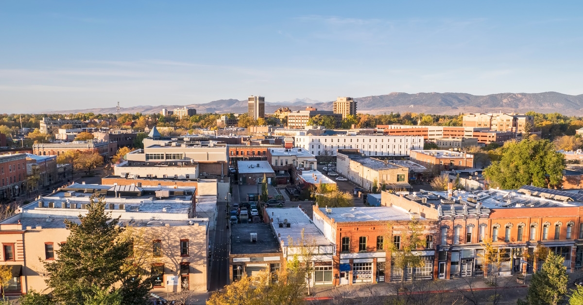 fort collins downtown buildings surrounded with trees during day time