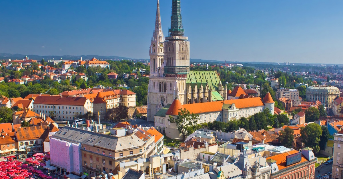 main square and cathedral area in zagreb with colorful buildings during day time