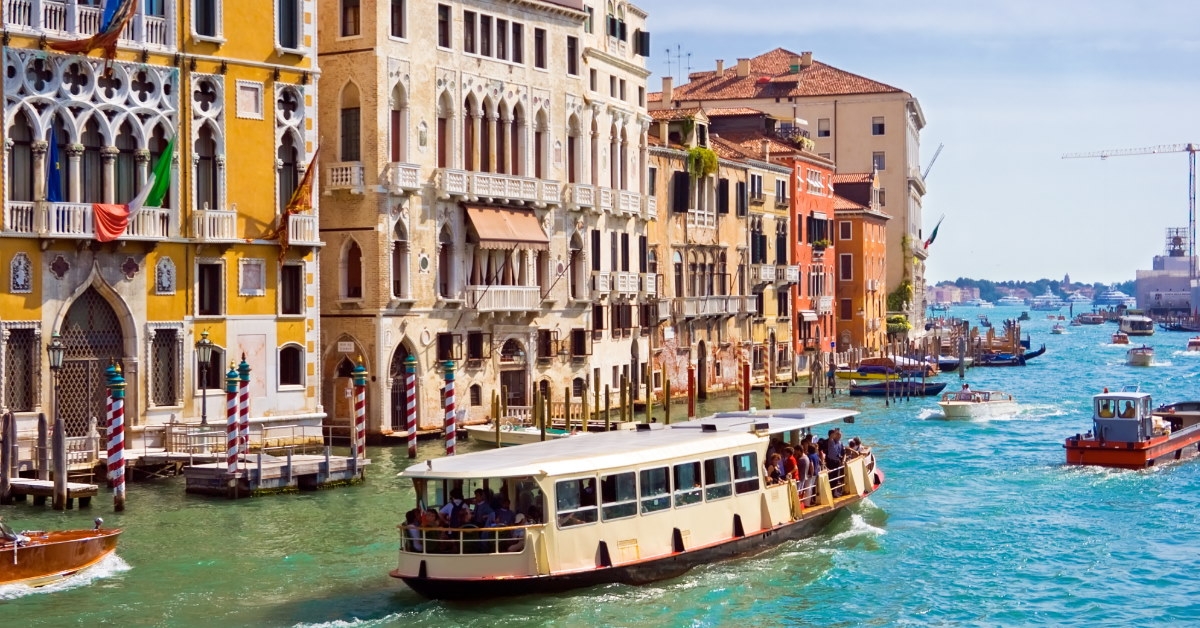 boat cruising in venice's grand canal during the day.