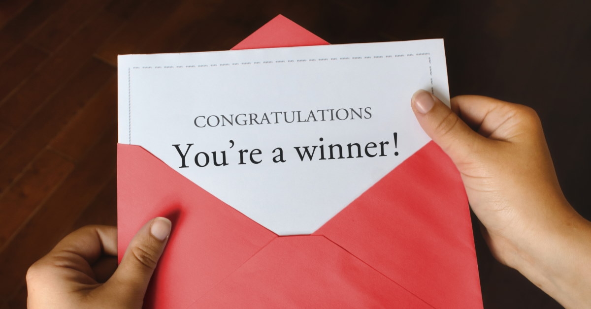 red envelope with white paper inside having congratulations you're a winner written over it
