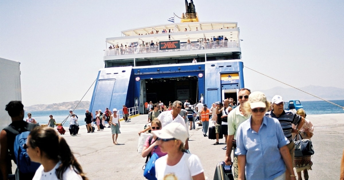 visitors getting out of ferry at harbor during day time