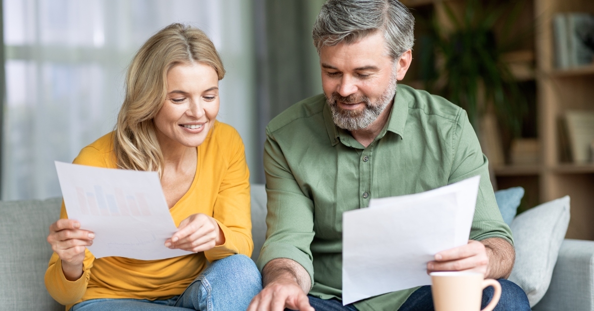 middle aged spouses checking finances