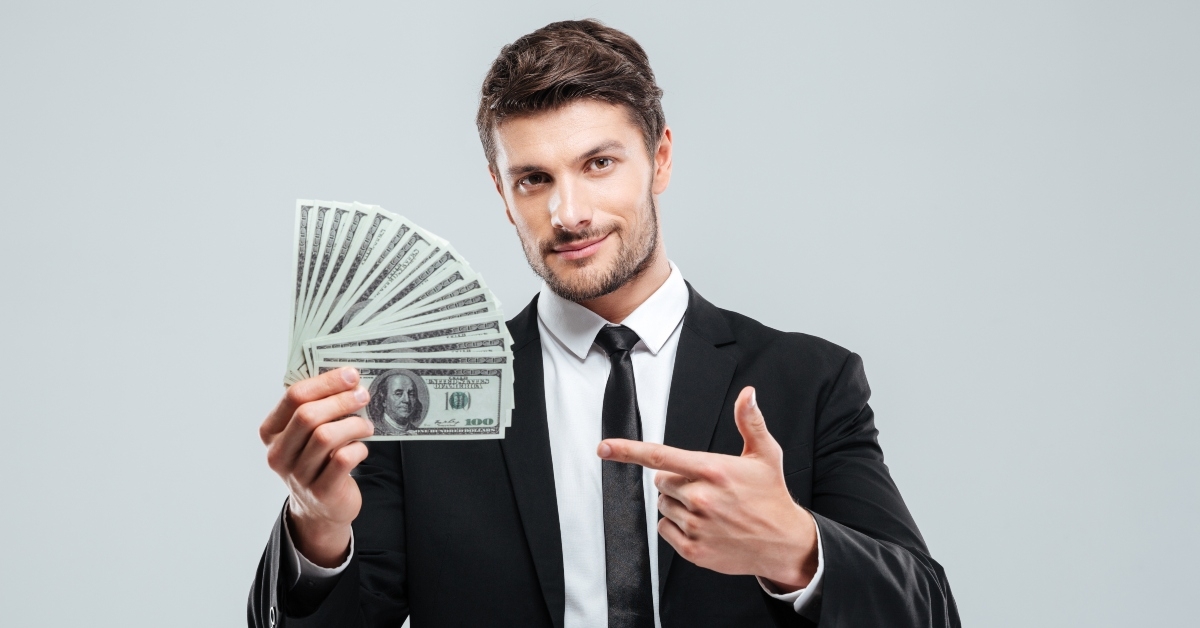 young businessman holding money