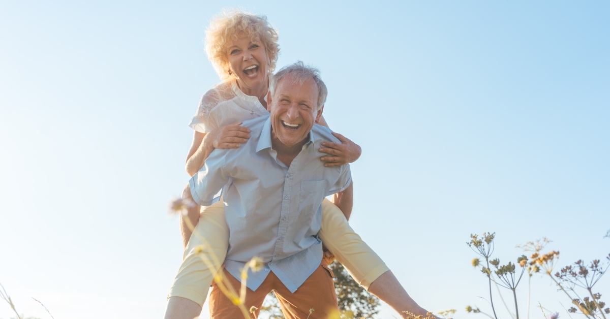senior couple happily playing piggy-back