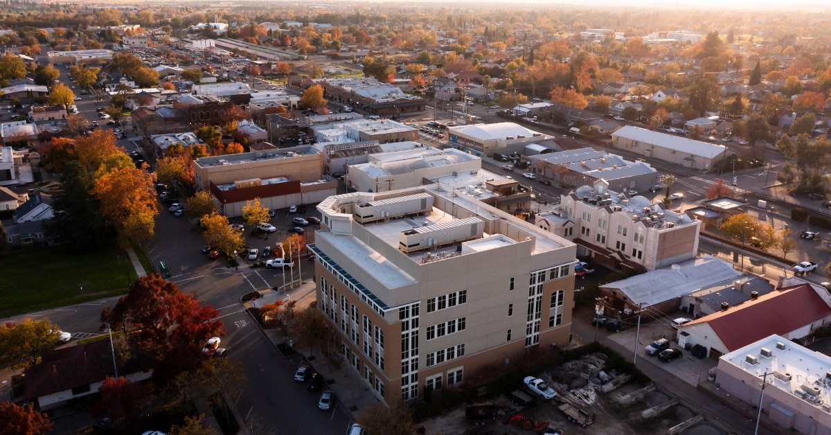 aerial view of buildings with streets full of cars in downtown lincoln california