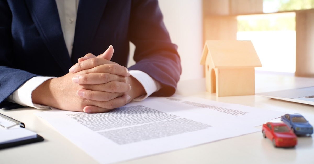 car sales manager sitting at table with papers