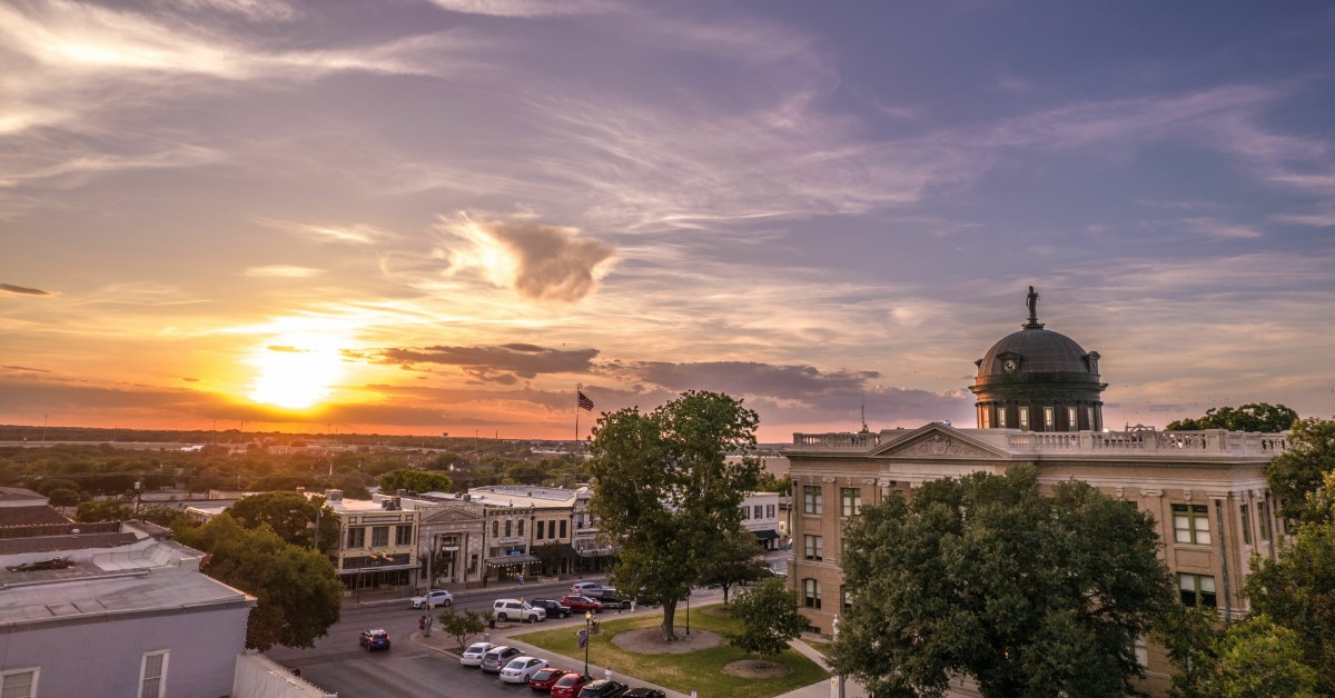 courthouse georgetown building with cars parked on streets at sunset