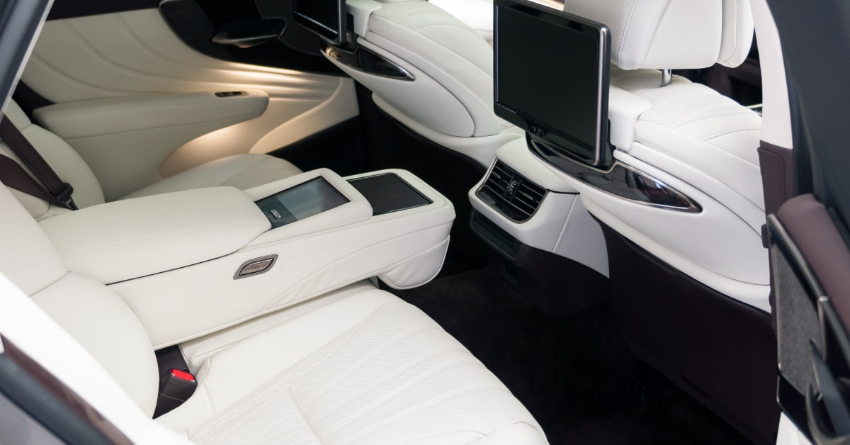 luxury interior of high end car with tv screens and spacious leather seats