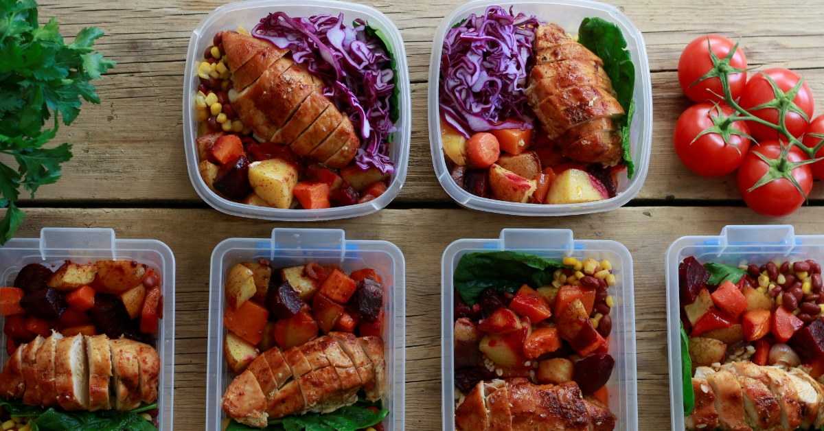 lunch boxes with healthy meals on wooden table