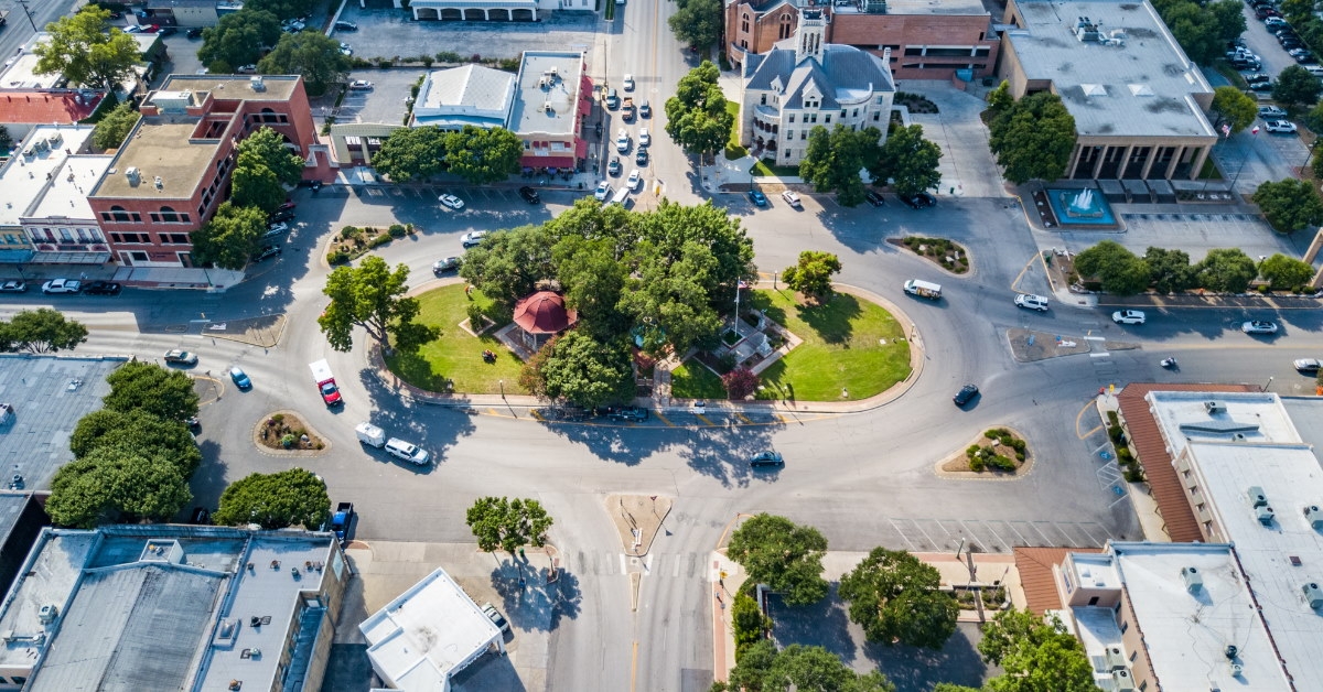cars driving around roundabout in new braunfels during day time