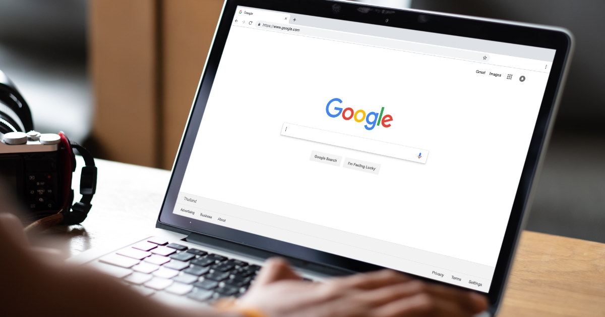 man using laptop to type on google search engine