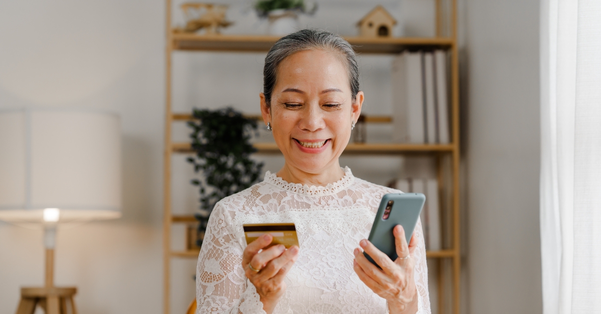 mature asian woman using credit card