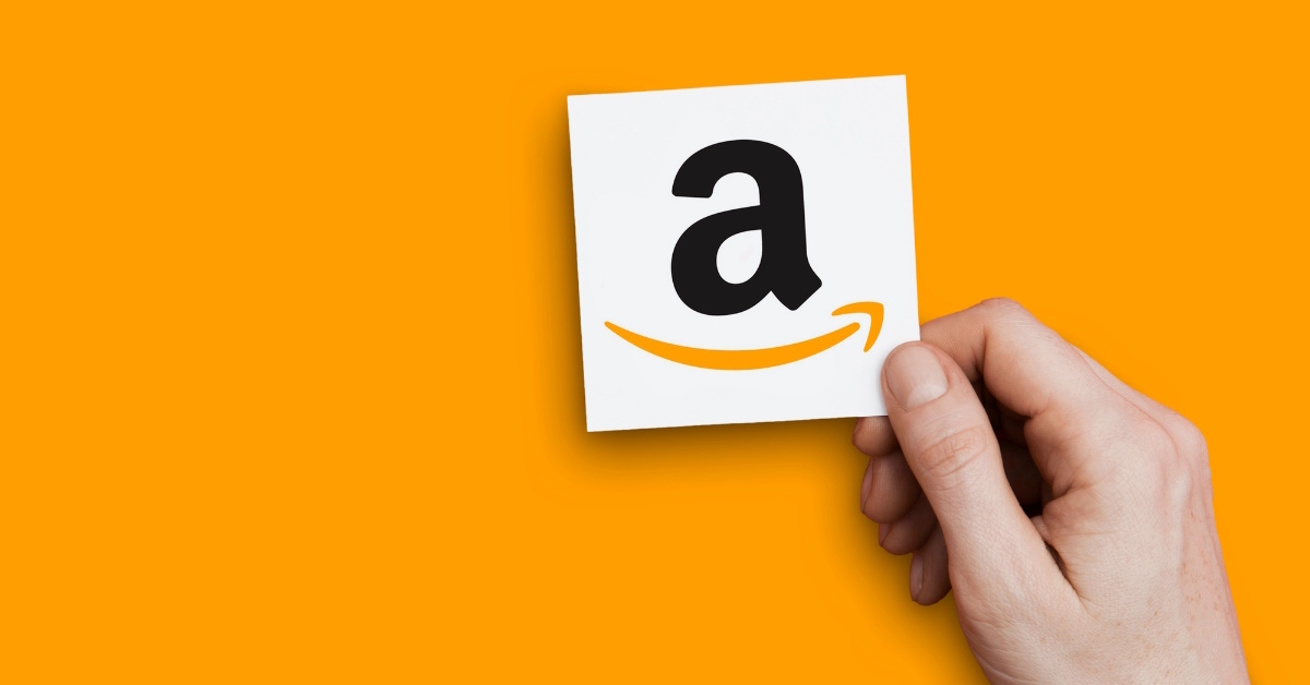holding amazon logo over white background