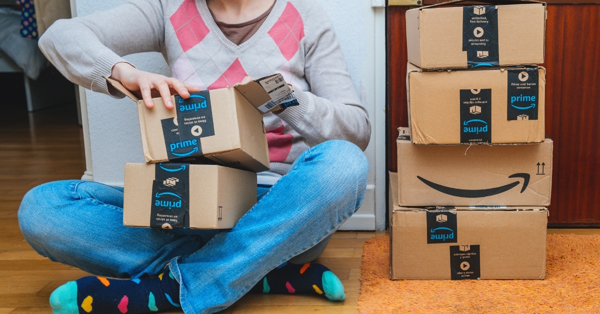 woman opening amazon parcels at home 