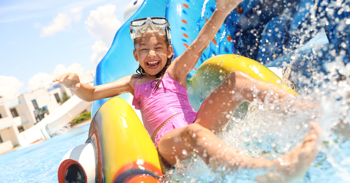 little girl on slide at water park