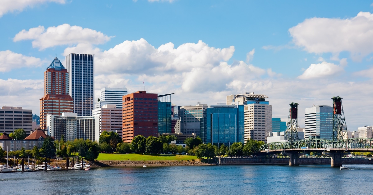 portland skyline in front of water during day time