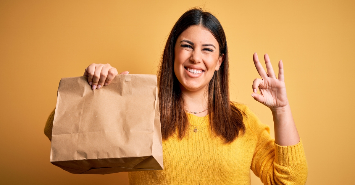 woman holding take away paper bag from delivery