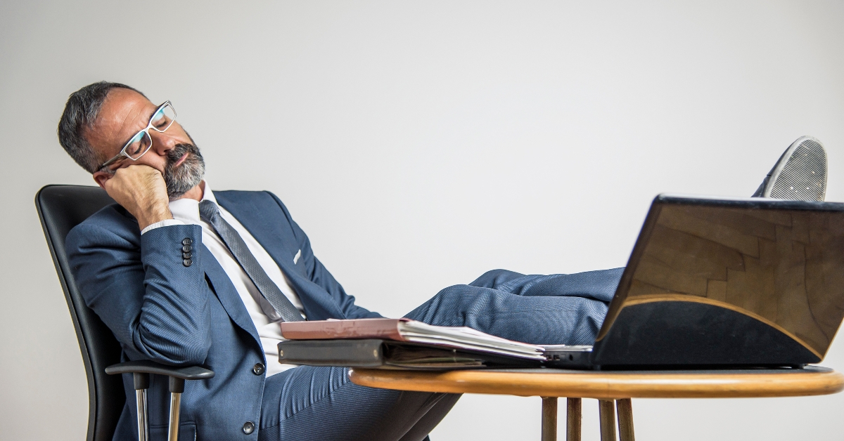 bored businessman is sleeping in his office