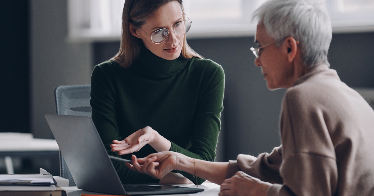 financial advisor pointing laptop while discussing options