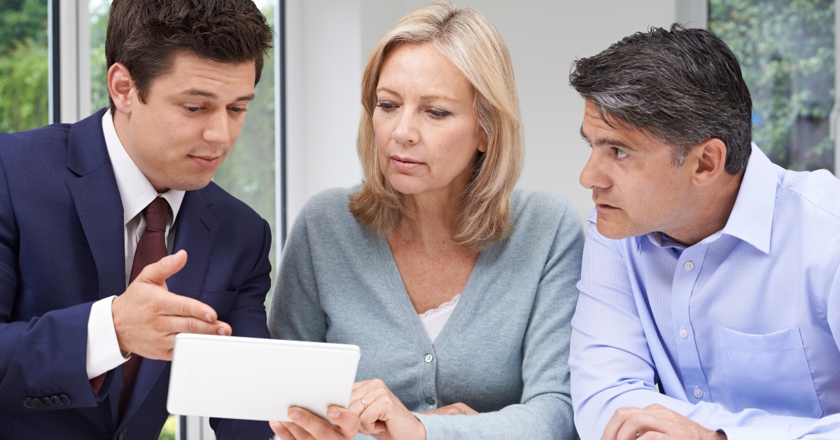 mature couple meeting with financial advisor at home