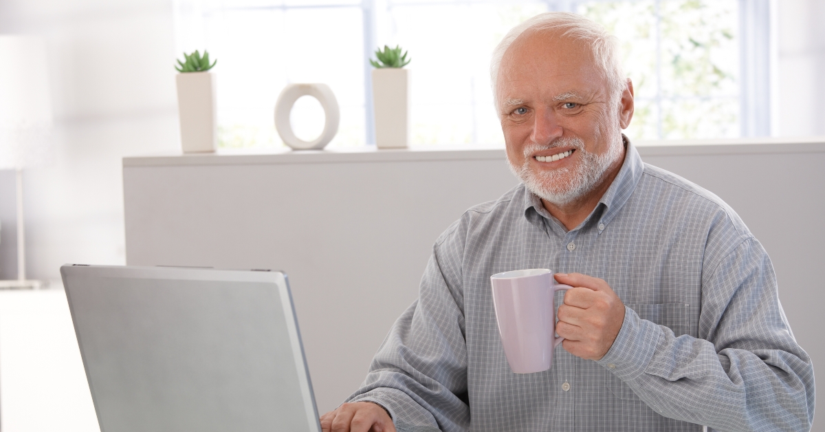 mature man with computer smiling 