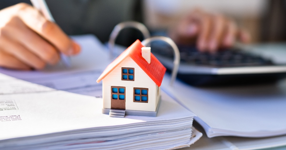 person hand doing property tax calculation using calculator
