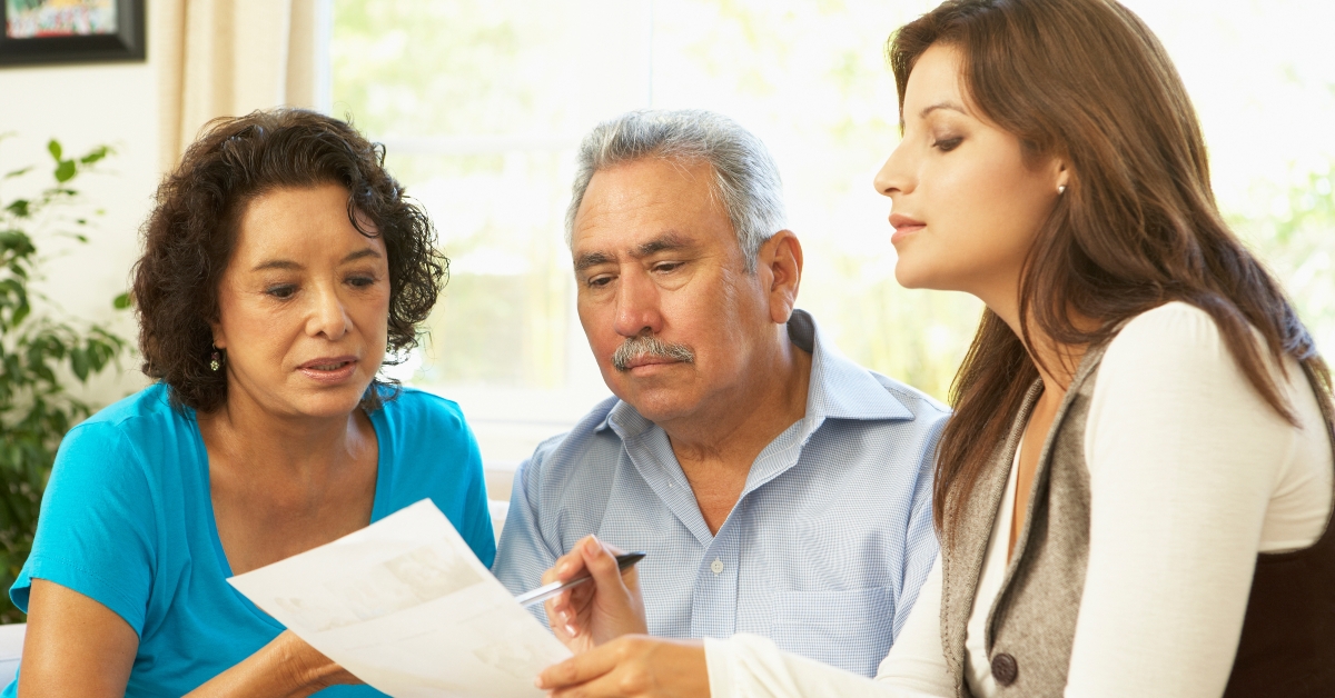senior couple with financial advisor at home