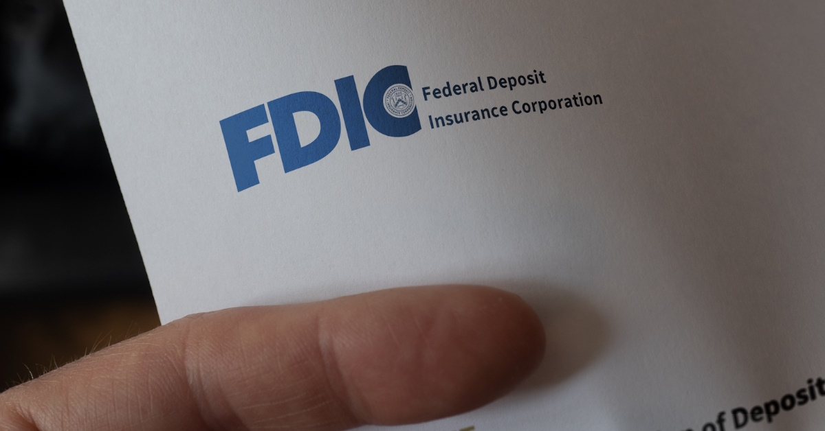 man holding letterhead with logo of federal deposit insurance corporation
