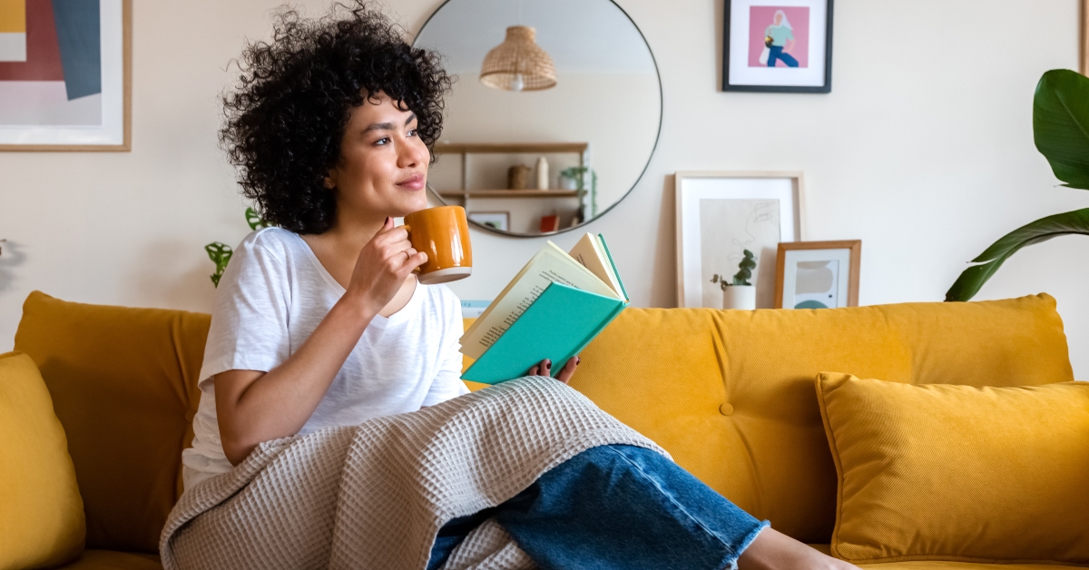 woman reading a book at home