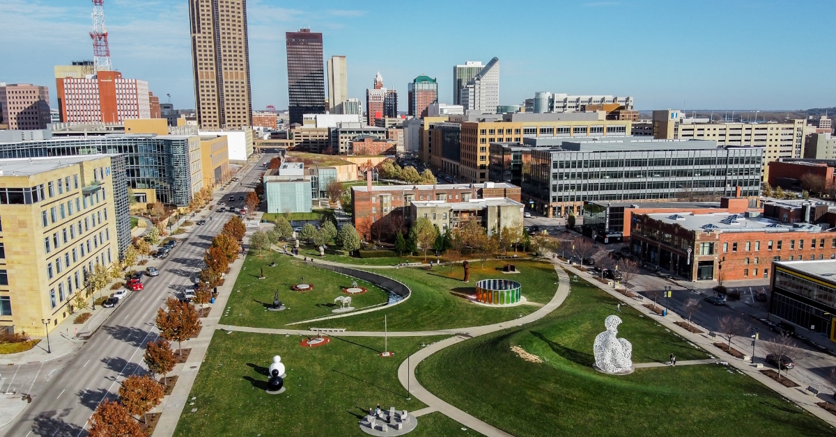 aerial shot of papa john sculpture park with buildings in background at des moines