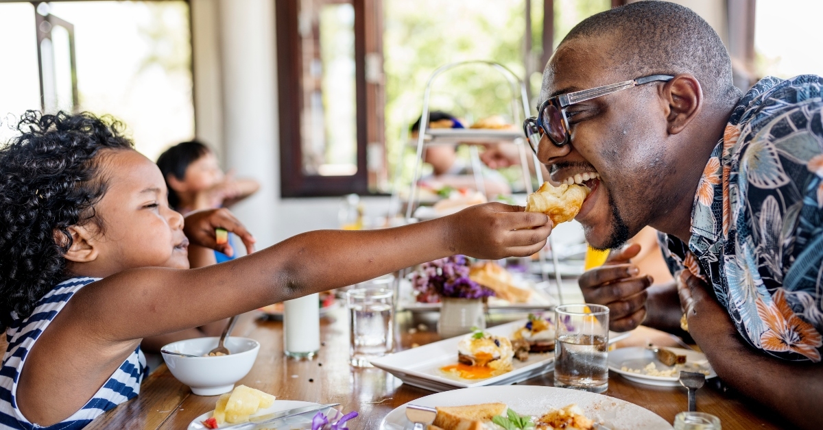 A father and daughter eating breakfast
