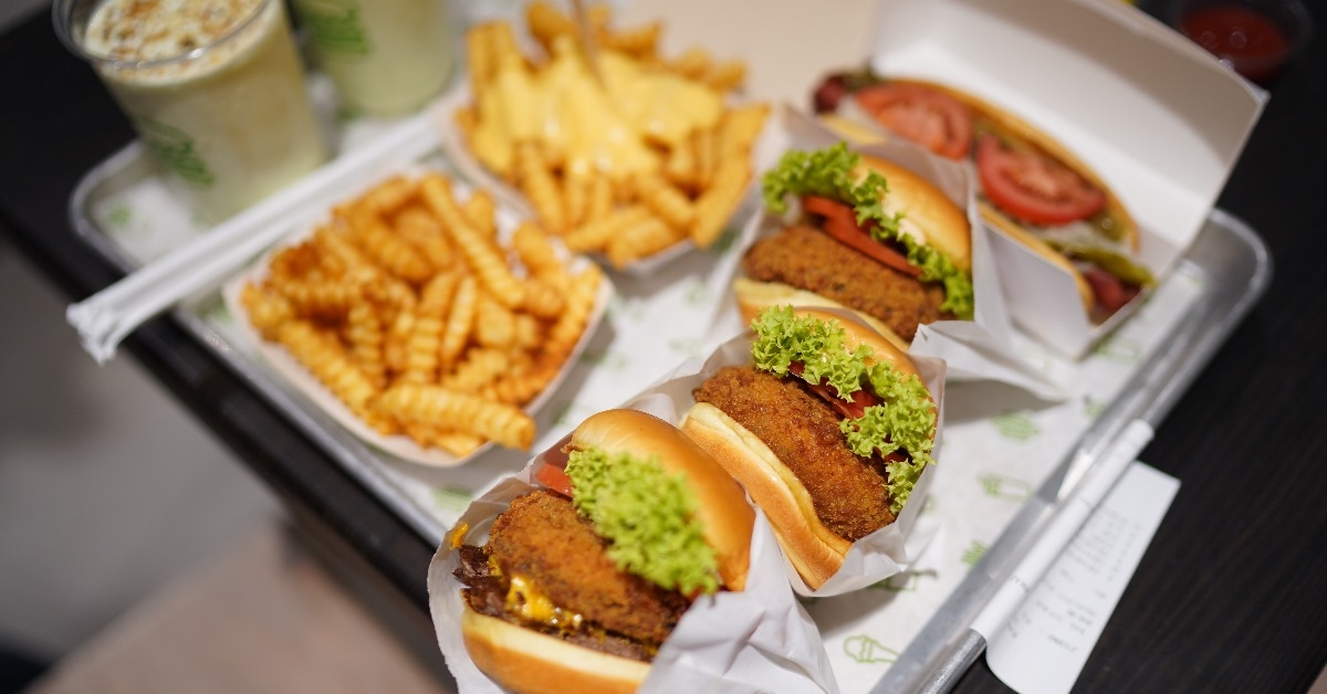 tray of freshly cook Shake Shack burget set with fries and drink.