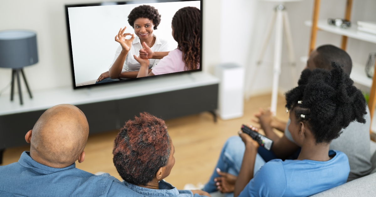 african family watching tv
