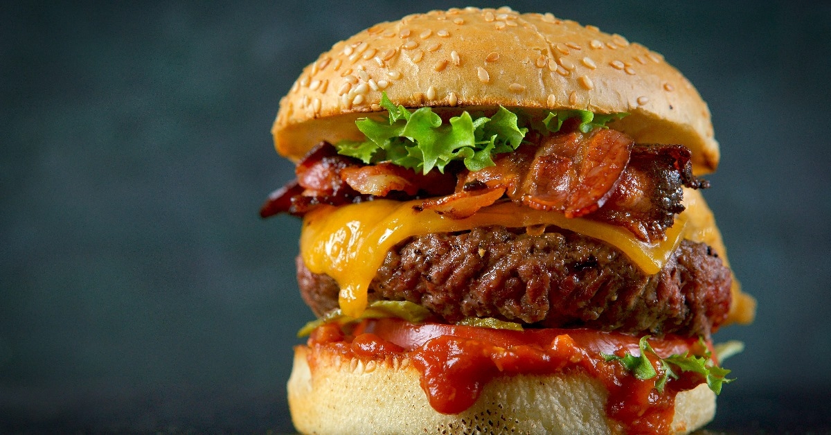 large burger with large beef patty ,melted cheese, bacon and sauces
