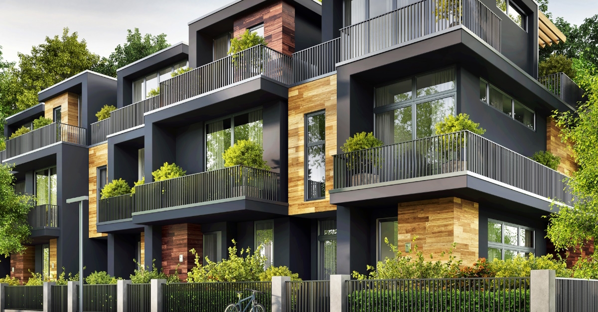 grey color modern town houses with lush greenery 