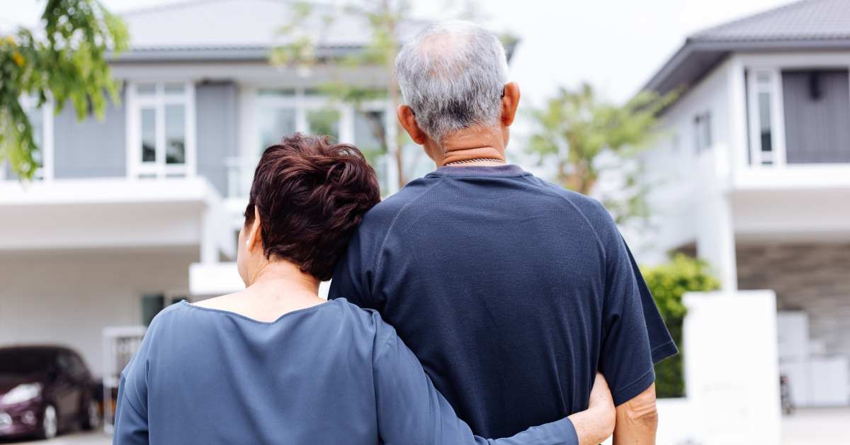 senior couple from behind looking at front of house