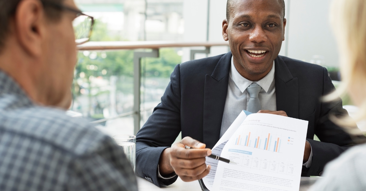 african american businessman talking to couple at office