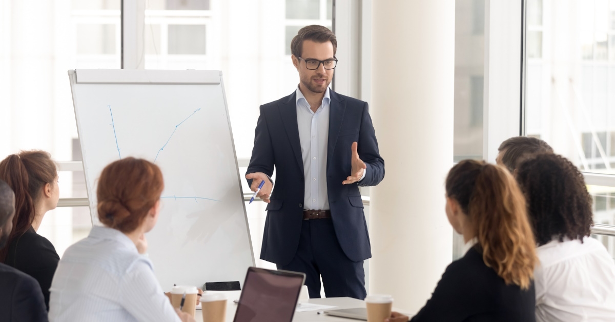 businessman explaining project to colleagues using flipchart