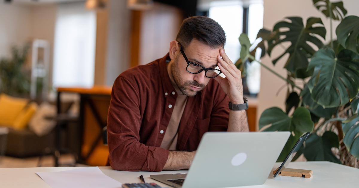 businessman in the home office feeling frustrated 