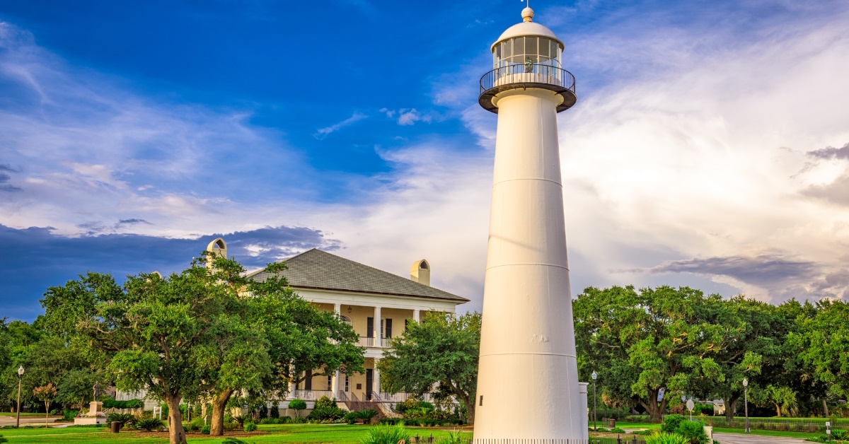 lighthouse in front of building with garden in biloxi mississippi