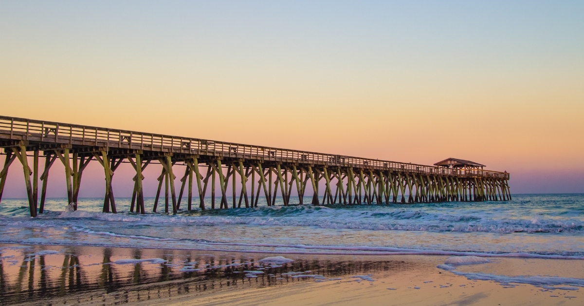 myrtle beach ocean pier with coastal tides at sunset 