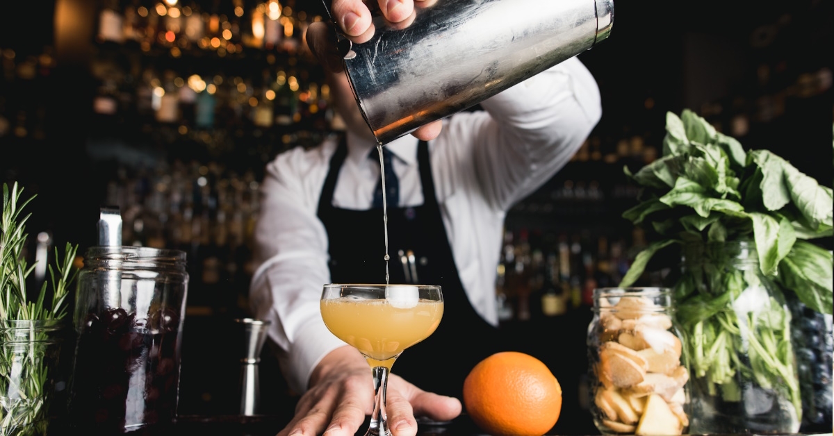 Male bartender making drink