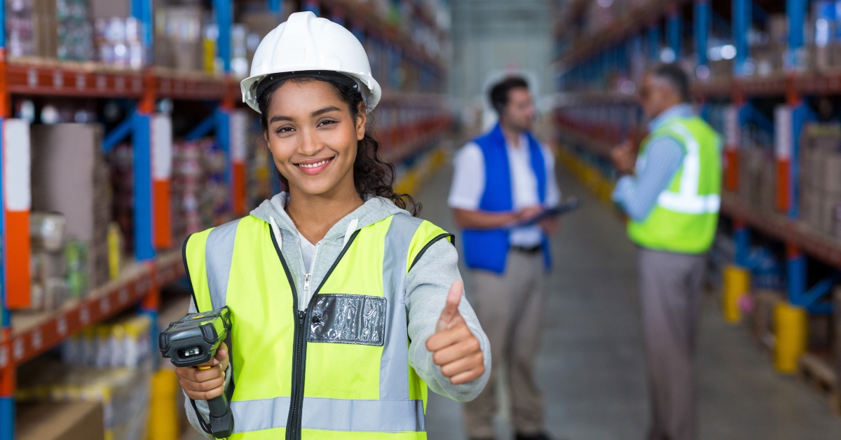 smiling female worker with thumb up