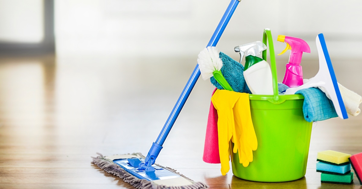 bucket with washing brush, spray set and other cleaning items 