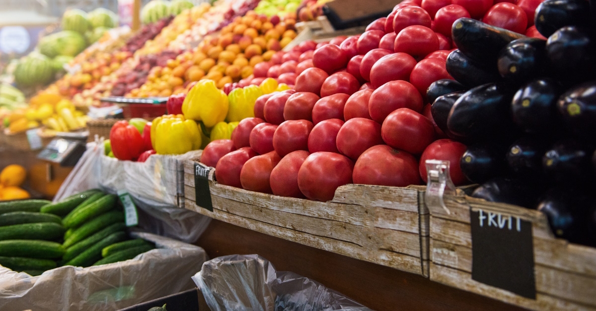 fresh organic vegetables in crates on shelves in grocery market