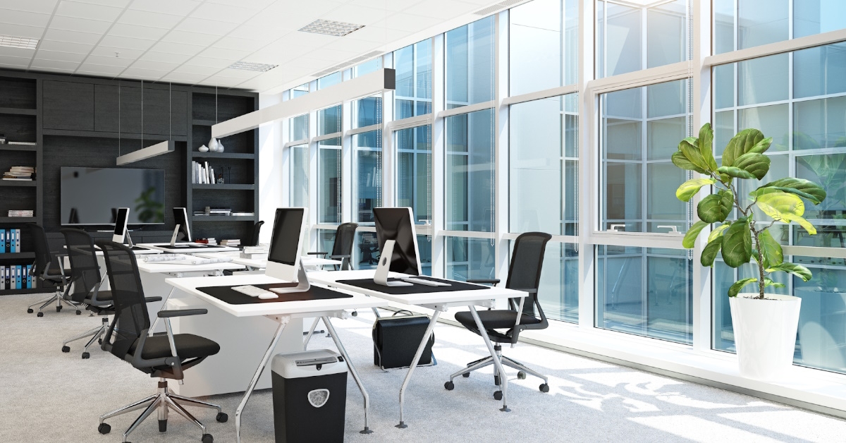 interior of a modern office with black furniture and large glass windows