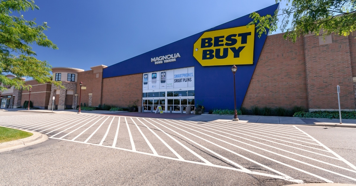 best buy store sign board on retail store in minnesota with vacant parking on sunny day