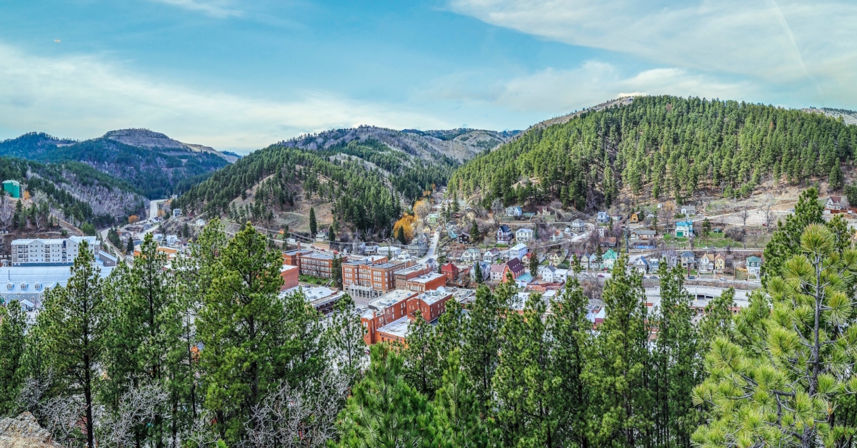  View from above of historical wild west town of Deadwood with hotels,resorts and numerous pine trees, in South Dakota USA.